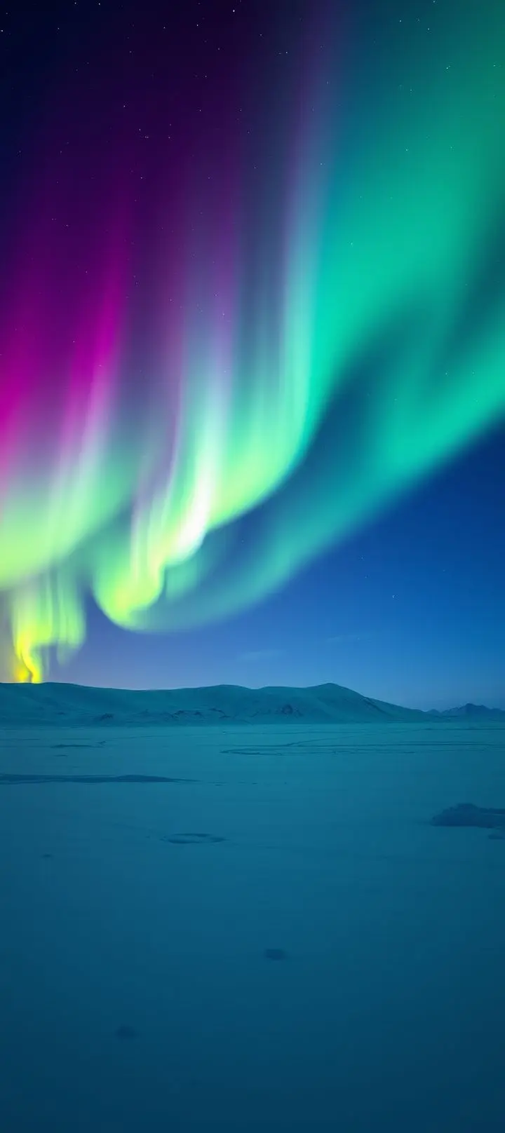 Northern lights in polar night sky over snowy mountains.
