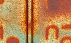 Close-up texture of pitted, rusted metal.