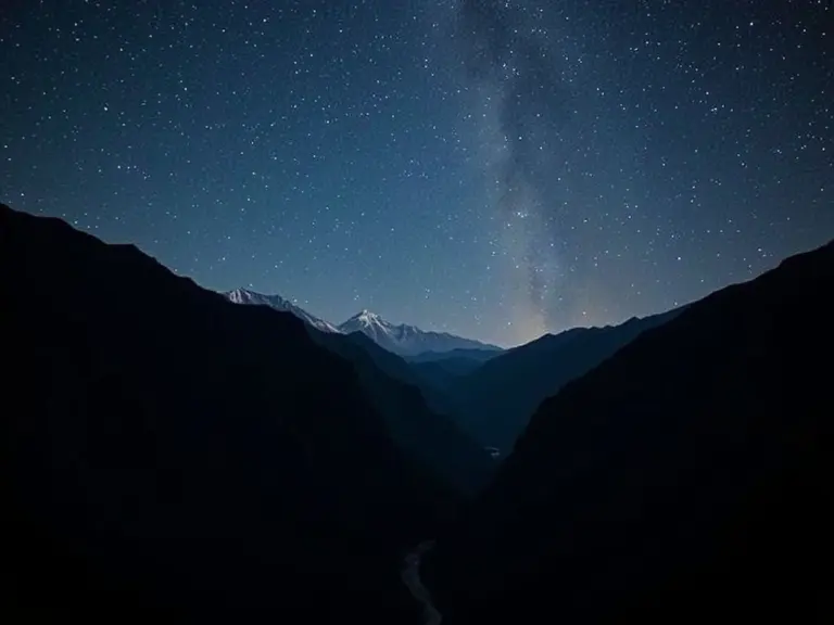 Night view of Dzhangitau Gora mountains under a starry sky.