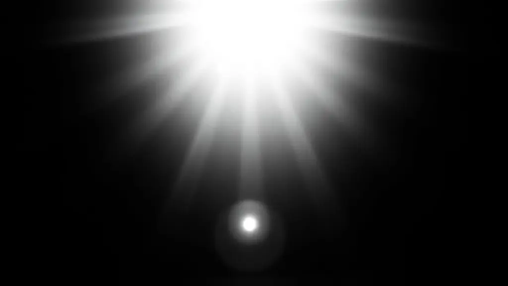 Grainy black and white close-up of a lightbulb resembling the sun.
