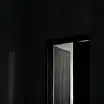 Dark luxury bedroom with faint light from door