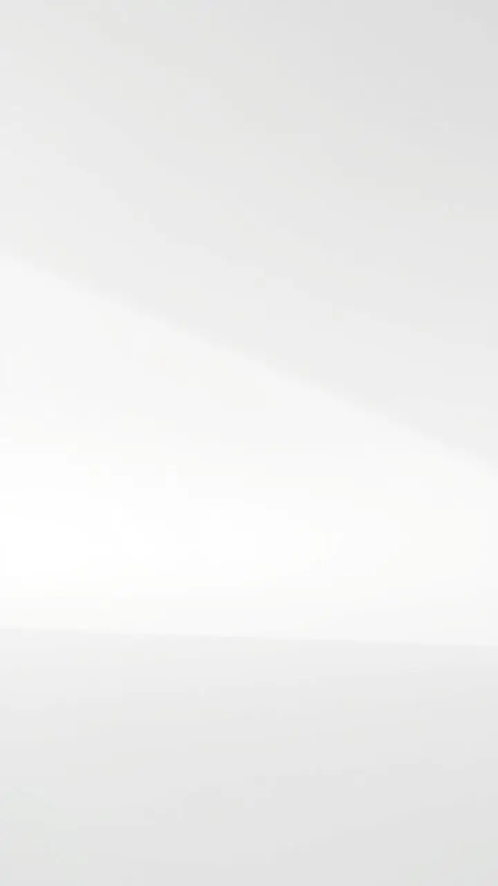 Minimalist white background with a single, central point of interest.