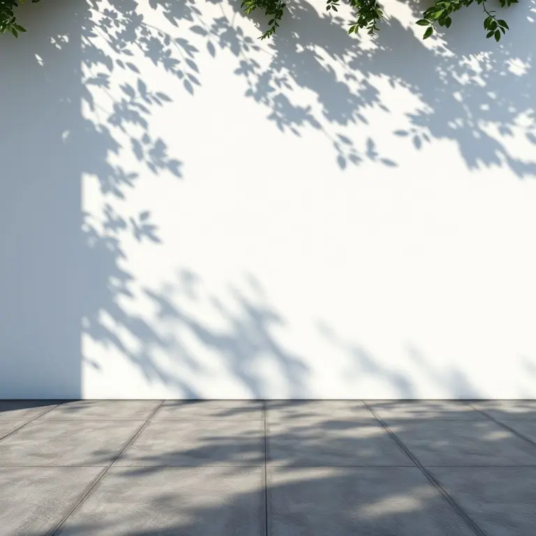 White stucco wall and charcoal gray tiles with dappled sunlight.