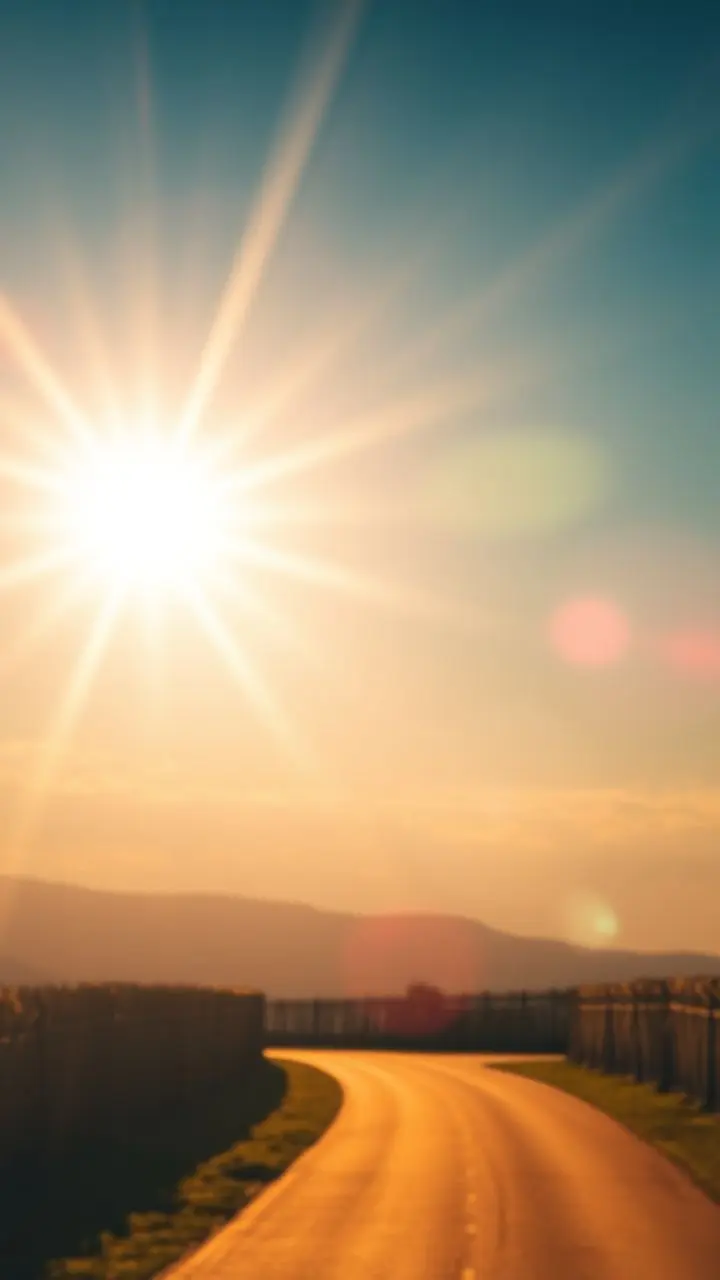 Bright sky with sunburst and shimmering lens flare.