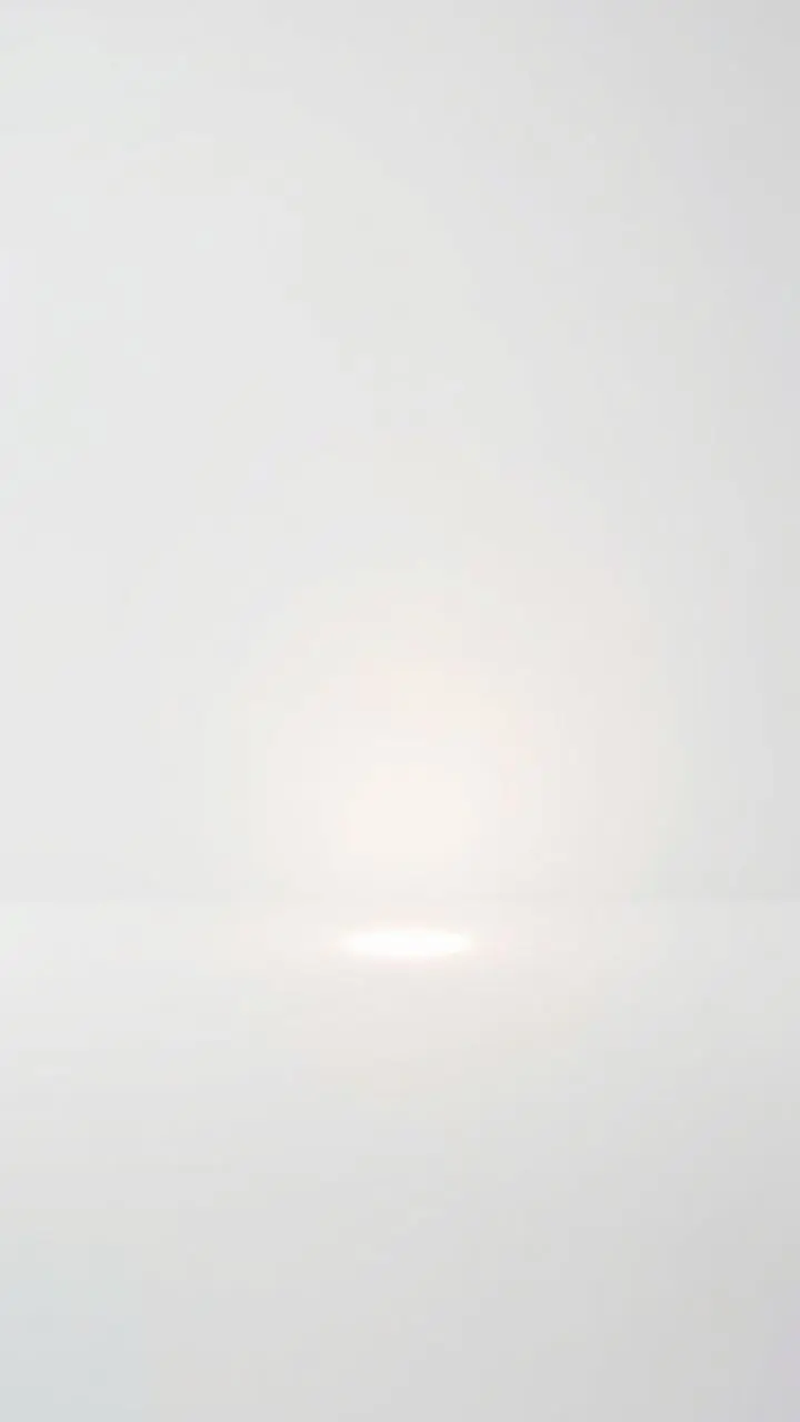 Minimalist composition with soft light on a white background.