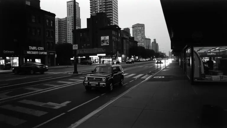 Grainy black and white photo of a city street.