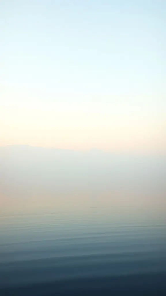 Dawn landscape with a calm lake and mist.
